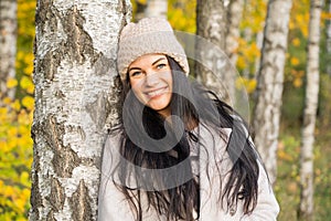 Beautiful young girl in the autumn forest on a sunny day