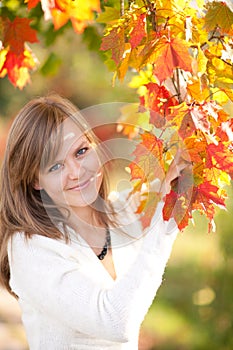 Beautiful young girl with autumn leaves