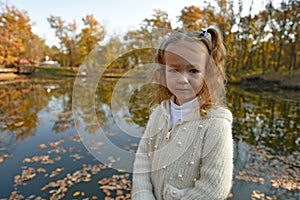 Beautiful young girl on an autumn walk in the village.