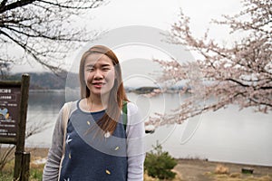 Beautiful young girl on background flowering apple-tree