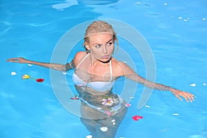 Beautiful young girl on the beach. Summer vacation and travel to ocean. Sexy girl in blue water on the beach. Vacation -