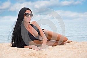 Beautiful young girl in a black bathing suit