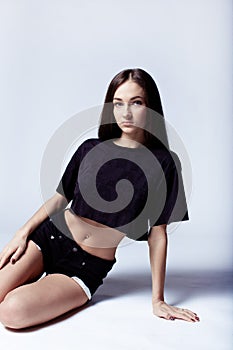 Beautiful young girl in black shorts and t-shirt