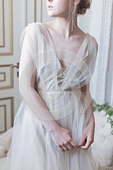 Beautiful young girl bride in a beautiful airy dress in beige colors , wedding in the style of boho