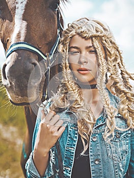 Beautiful young girl with brown horse