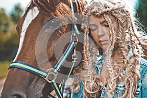 Beautiful young girl with brown horse