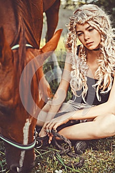 Beautiful young girl with brown horse