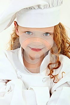 Beautiful Young Girl Child in Chef Uniform and Hat