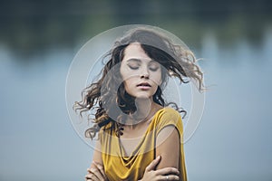 Beautiful young girl closeup portrait on the background of water