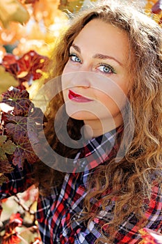 Beautiful young girl in colorful grape vineyard