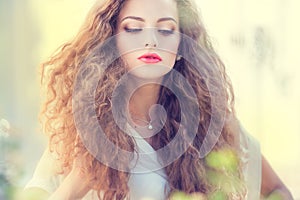 Beautiful young girl with curly hair