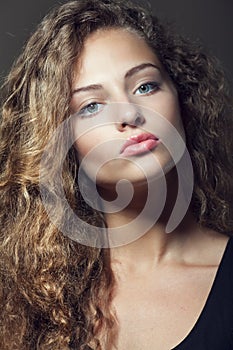 Beautiful young girl with curly hair