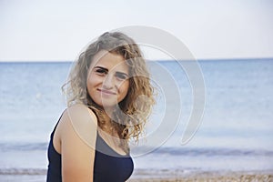 Beautiful young girl curly hair portrait happiness sea beach