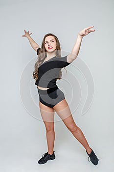 Beautiful young girl in the dance movement. Studio photography of a girl dancer