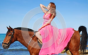 The beautiful young girl dances on coast