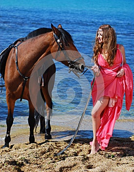 The beautiful young girl dances on coast