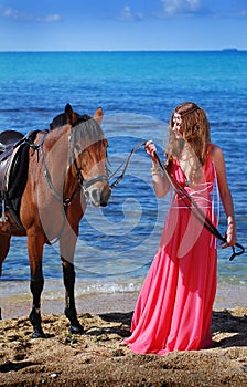 The beautiful young girl dances on coast