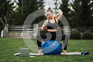 Beautiful young girl doing exercises with fit ball