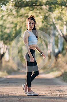 beautiful young girl doing sports workout in the park