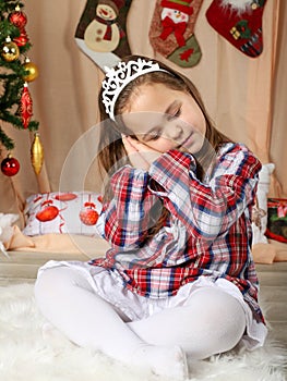 Beautiful young girl dreaming for gifts for christmas