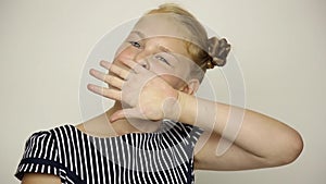 Beautiful young girl dressed in a striped dress eating an apple. healthy food - strong teeth concept