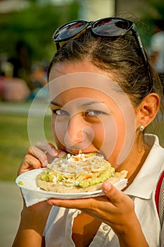 Beautiful young girl eating a tostada soft taco photo