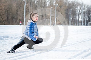 A beautiful young girl is engaged in stretching and gymnastics i