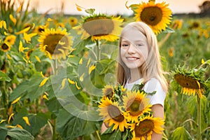 Beautiful young girl in a field of sunflowers