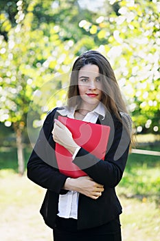 Beautiful young girl with folder