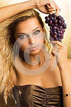 Beautiful young girl with grapes