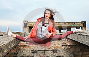 Beautiful young girl gymnast took the pose of twine photo