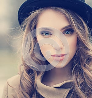 Beautiful young girl in hat outdoors