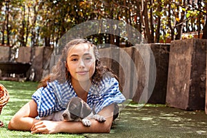 Beautiful young girl having fun with her small French Braque puppies