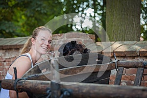 Beautiful young girl and her dog black schnauzer