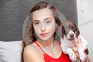 Beautiful young girl with her small French Braque puppy