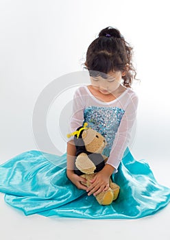 A beautiful young girl with her teddy bear