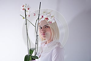 Beautiful Young Girl Holding an Orchid Flower: Studio Portrait