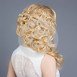 Beautiful young girl in the image of the bride, beautiful wedding hairstyle with flowers in her hair, hairstyle for bride