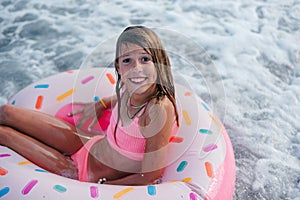Beautiful young girl with inflatable donut