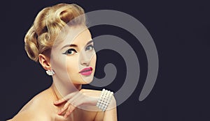 Beautiful young girl with jewels. Makeup in sixties style