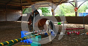 Beautiful young girl jumping in a horse farm