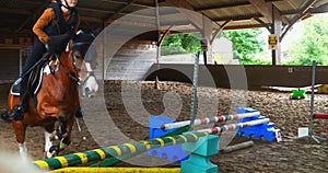 Beautiful young girl jumping in a horse farm