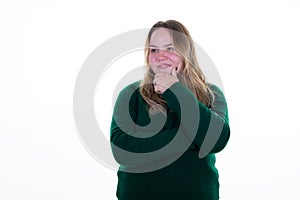 Beautiful young girl keeping hand in hair and looking on camera chubby woman standing aside copyspace white background