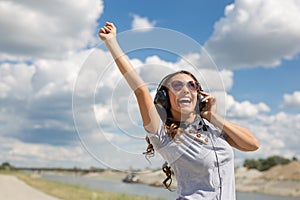 Beautiful young girl listening to music on headphones