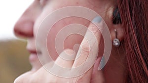 Beautiful young girl listens to music in headphones, close up