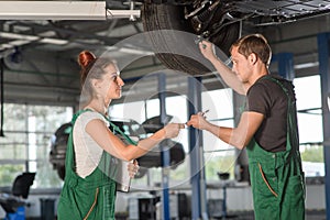 A beautiful and young girl locksmith conducts diagnostics of the