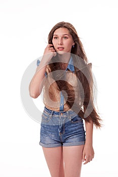 Beautiful young girl with long hair shows different emotions. Photographing on a white background