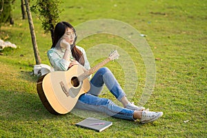 The beautiful young girl long hair sit on the field vacant look