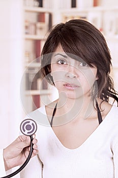 Beautiful young girl looking nervous at the doctor