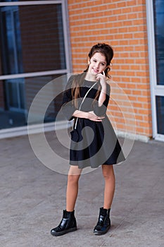 Beautiful young girl with a lot of packages at the outlet of the